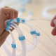 The minimally invasive surgery involves using a catheter to block an artery key to producing ghrelin. Above, an employee assembling catheters.